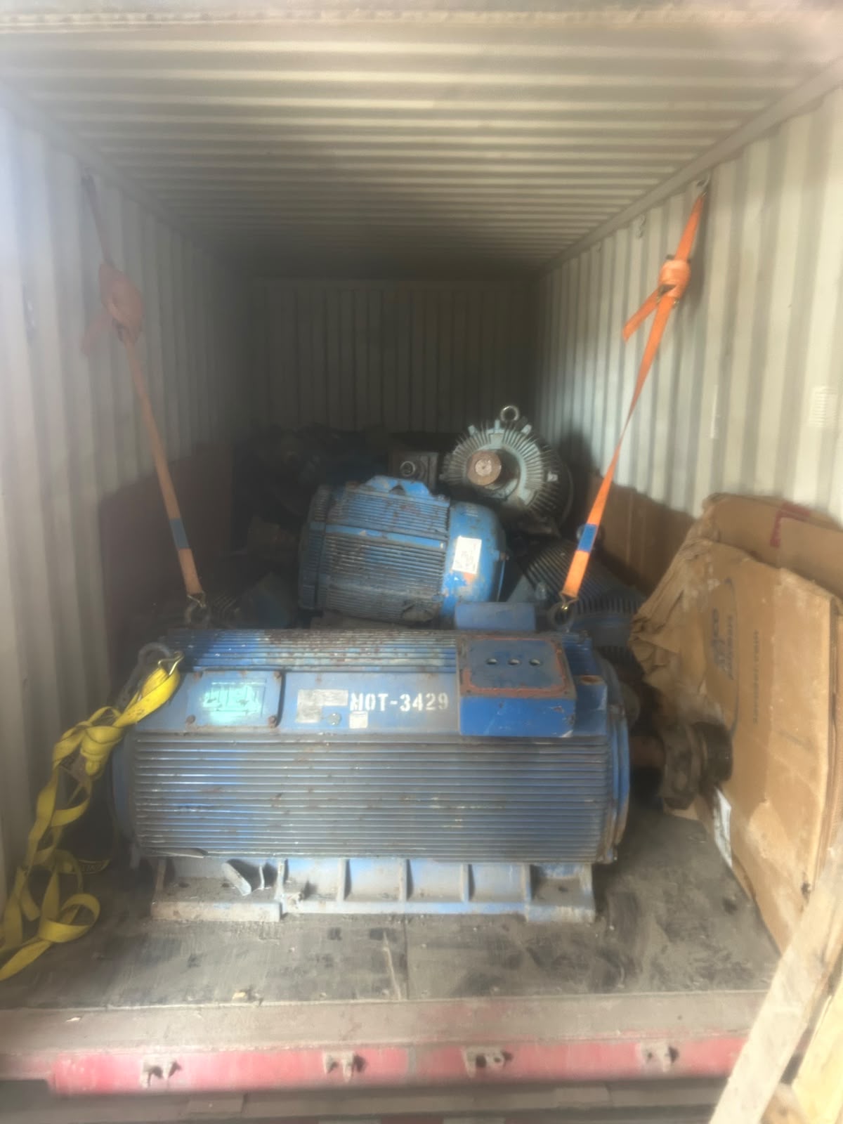 Large industrial motors staged inside a container