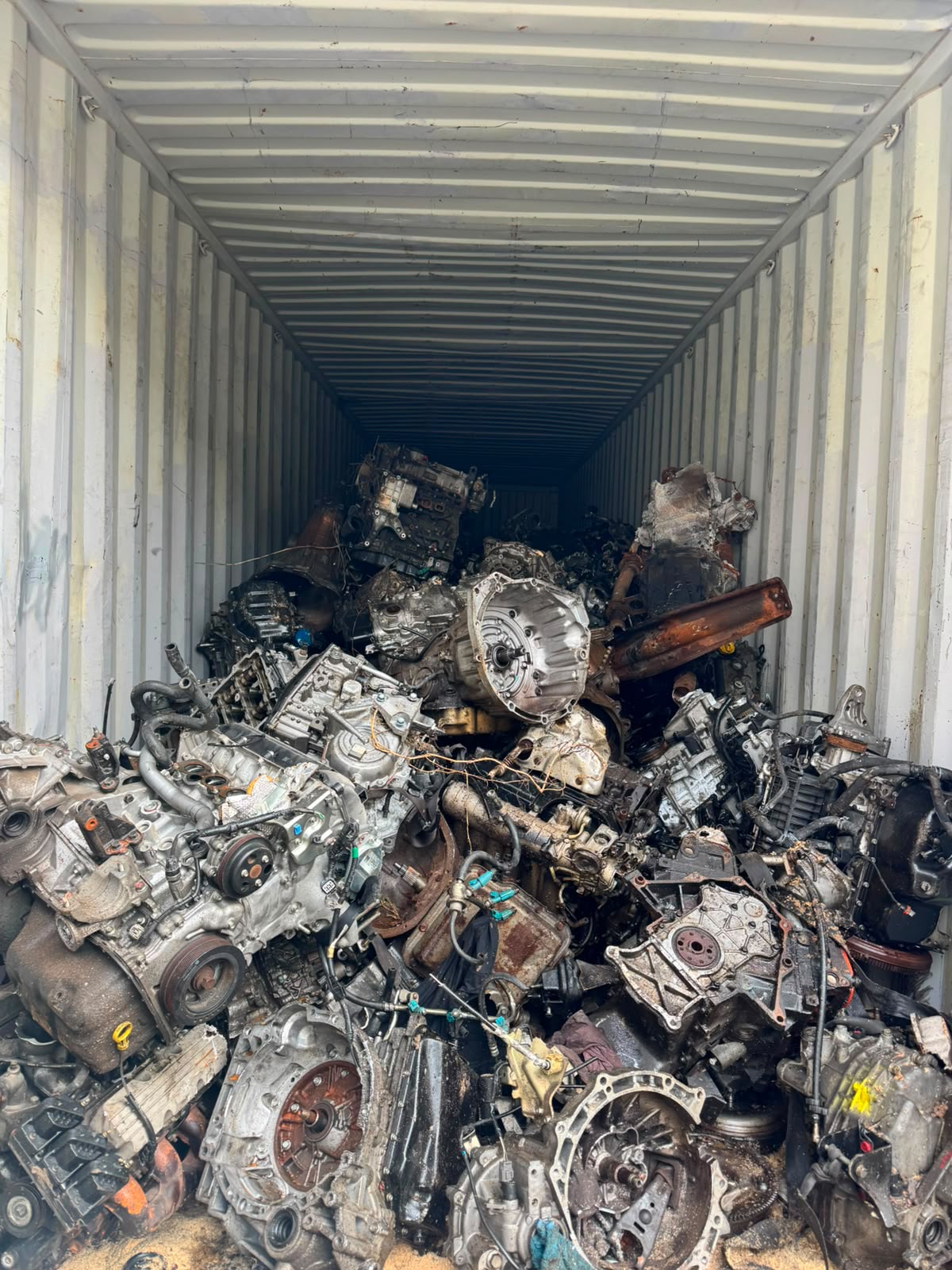 Industrial engines and transmissions staged in a container for evaluation